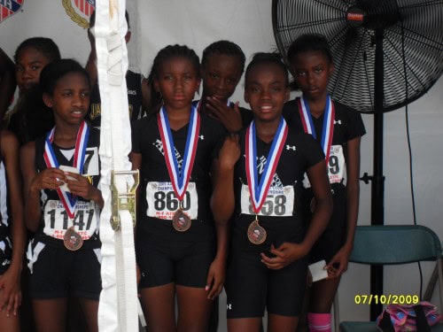 Young female track athletes with medals at Panthers Elite Track & Field Club event.