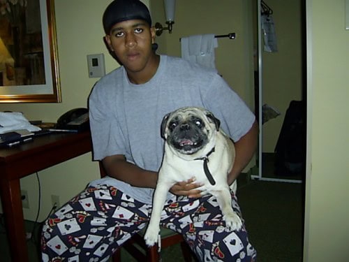 Young athlete with a dog at Panthers Elite Track & Field Club.