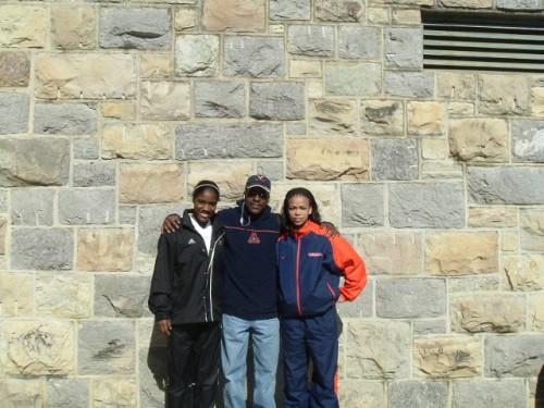 Panthers Elite Track & Field team members posing outdoors against a stone wall.