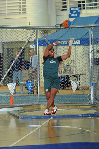 Long jump athlete preparing to jump at indoor track facility.