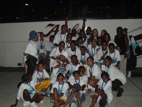 Group of young athletes from Panthers Elite Track & Field Club at night.