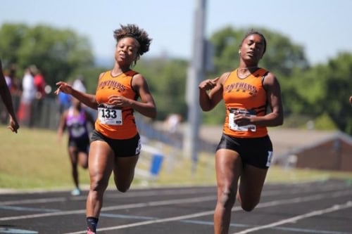 Fast female sprinters competing in a track race at Panthers Elite Track & Field Club event.