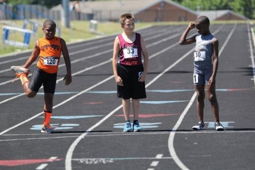 Young athletes preparing for a race on the track at Panthers Elite Track & Field Club.