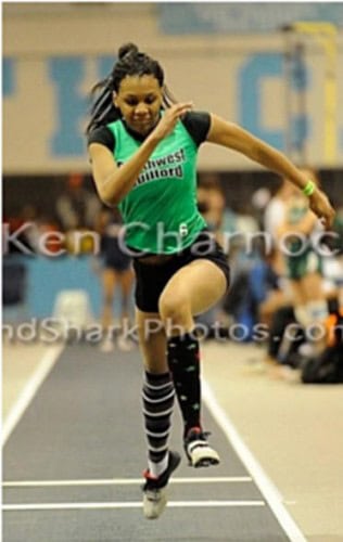 Fast female athlete sprinting during indoor track event at Panthers Elite Track & Field Club.