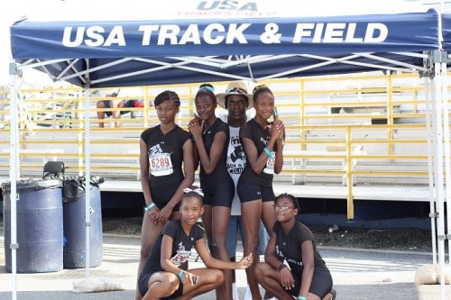 Panthers Elite Track & Field team posing under a USA Track & Field tent.