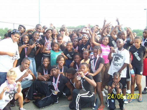 Group of young athletes celebrating at Panthers Elite Track & Field Club event.