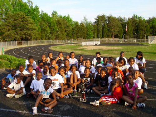 Group of young athletes at Panthers Elite Track & Field Club on the running track.