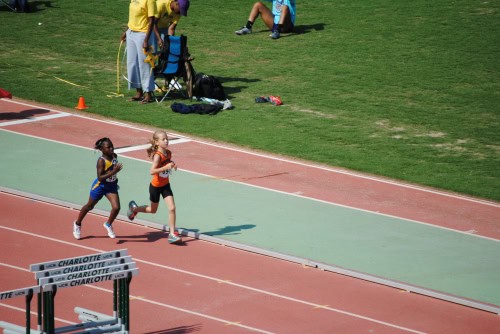 Young athletes competing in a track race at Panthers Elite Track & Field Club meet.