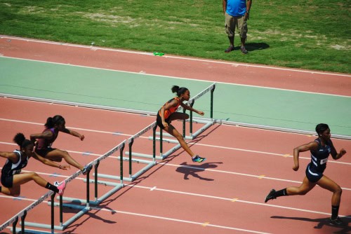Female athletes competing in hurdles at Panthers Elite Track & Field meet.