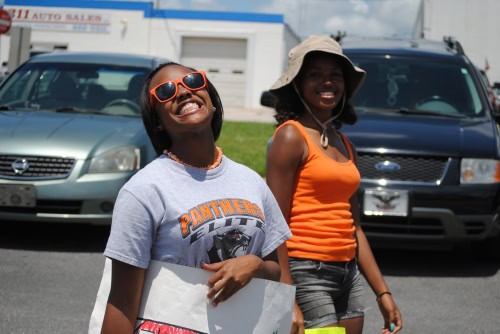 Two young female athletes smiling outdoors at Panthers Elite Track & Field event.