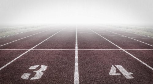 Track starting line with lanes 3 and 4, ready for race.