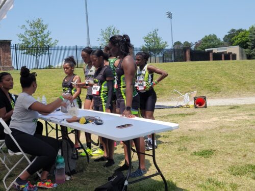 Athletes receiving awards at a track meet event.