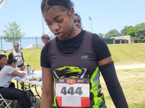 Young female athlete in Panthers Elite uniform preparing for a race.