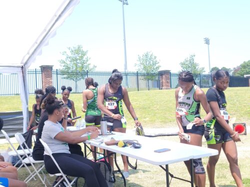 Athletes preparing for a race at a track meet.