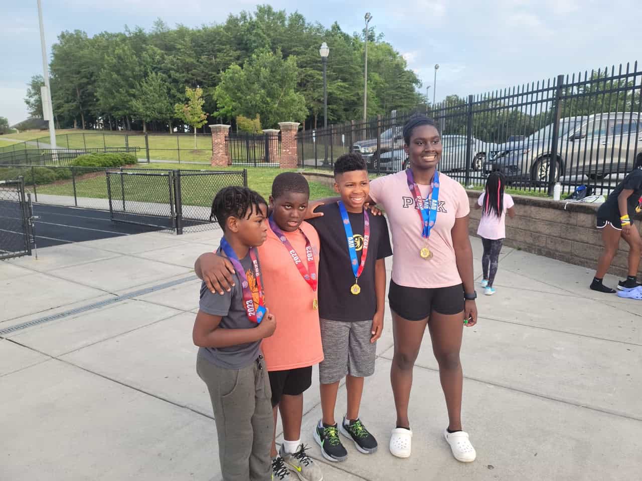 Young athletes with medals at Panthers Elite Track & Field event.
