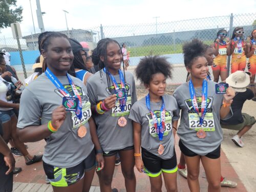 Young athletes holding medals after a race.