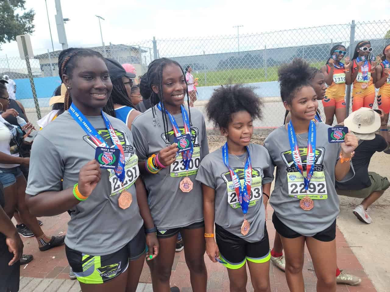 Young athletes holding medals after a race.