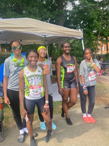 Young athletes from Panthers Elite Track & Field Club posing outdoors.