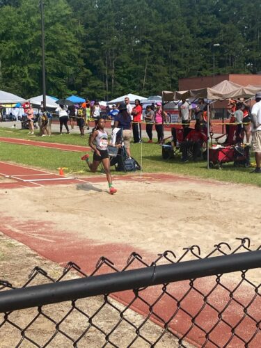 Young athlete running on the track during a meet.