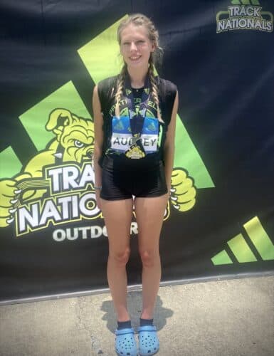 Young female athlete with medal at Track Nationals.