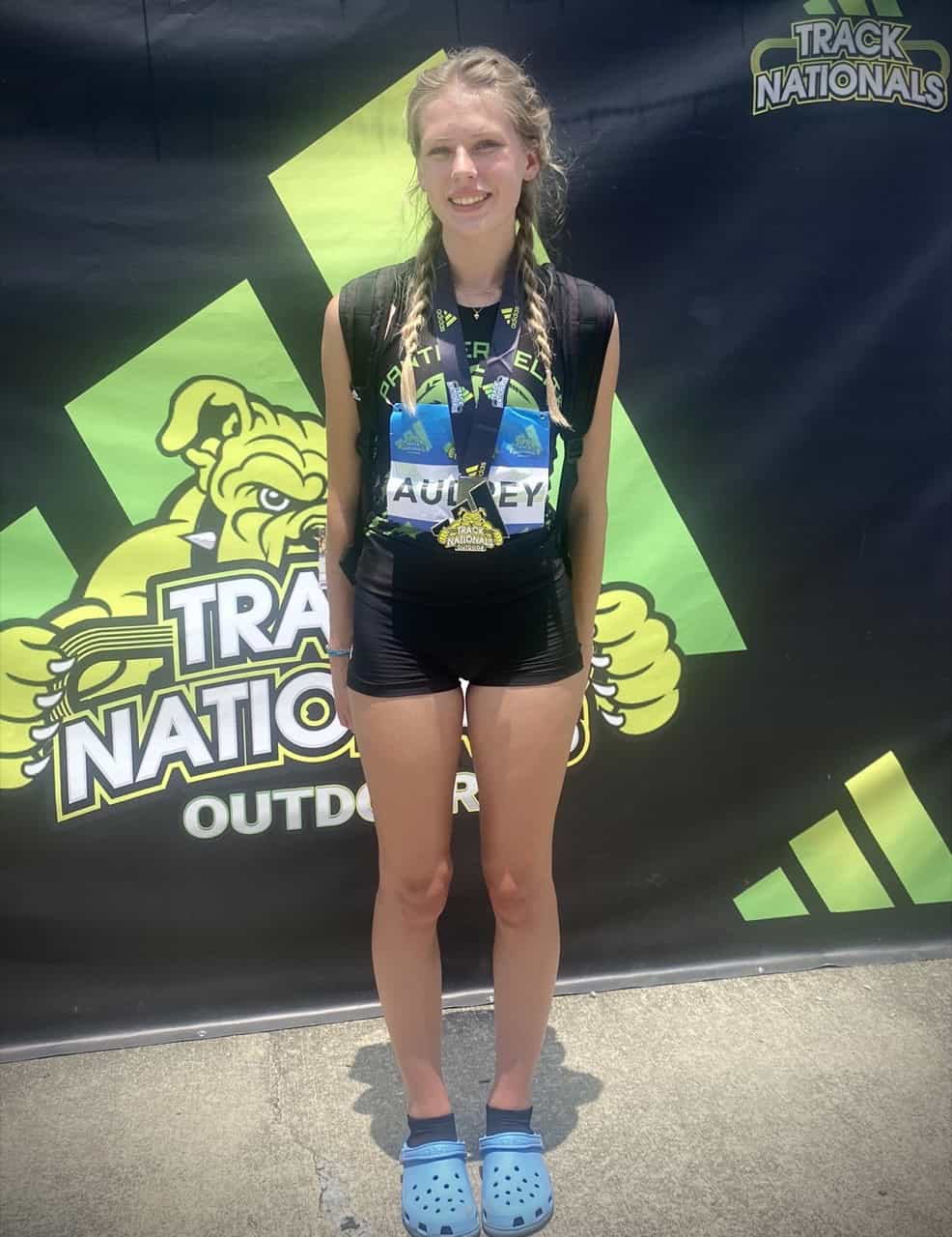 Young female athlete with medal at Track Nationals.