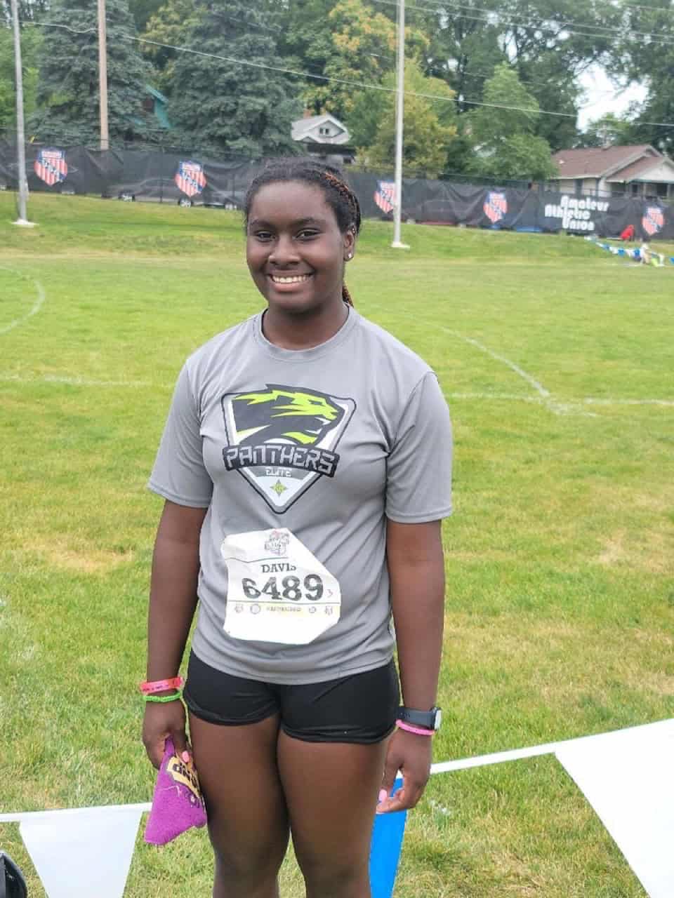 Young female athlete smiling at the track meet.