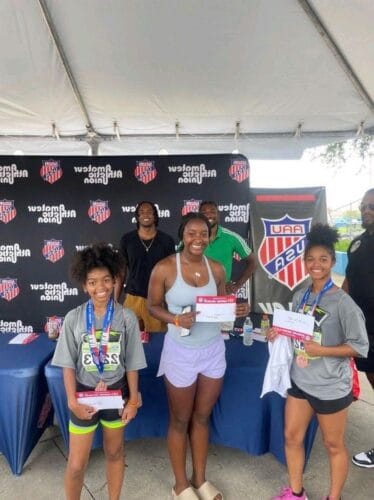 Young athletes receiving awards at Panthers Elite Track & Field event.