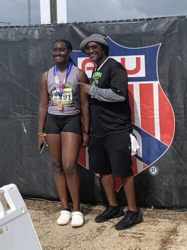 Female athlete with coach at Panthers Elite Track & Field event.