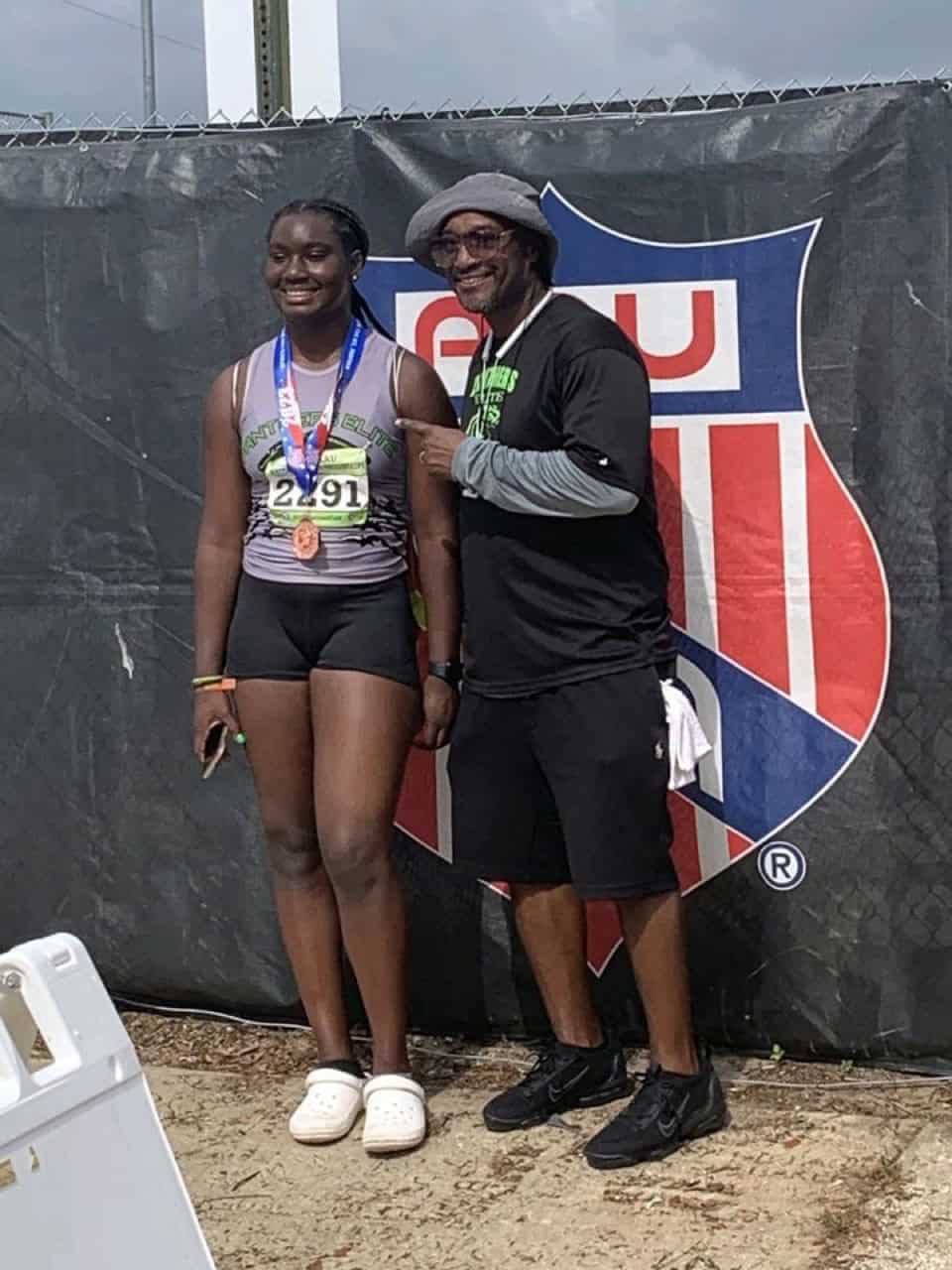Female athlete with coach at Panthers Elite Track & Field event.