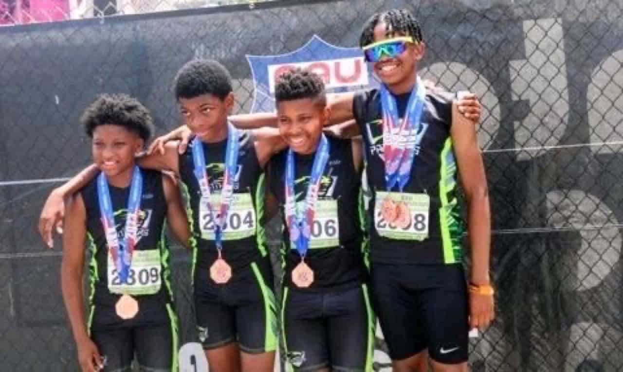 Young athletes celebrating with medals after a race.