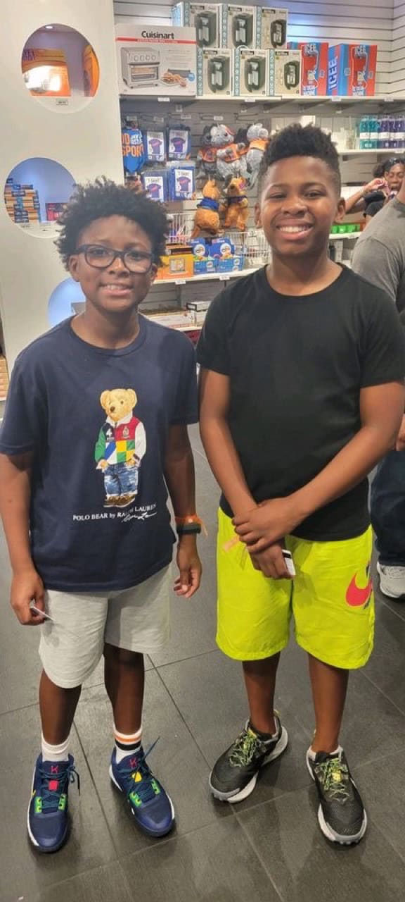 Young athletes smiling at the store.
