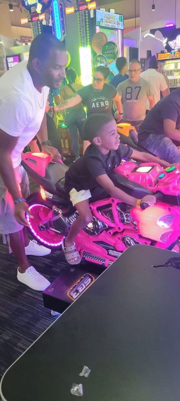 Young athletes enjoying arcade games at Panthers Elite Track & Field event.