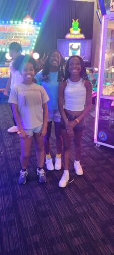 Panthers Elite athletes at an indoor event, smiling and posing together in a vibrant sports facility.