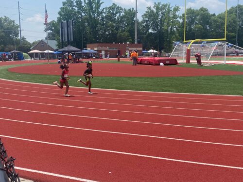 Panthers Elite athletes running on the track during a meet.