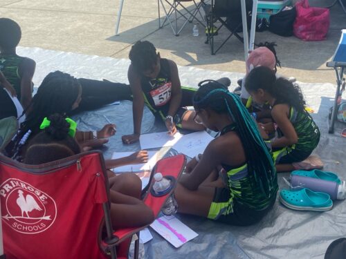 Young athletes studying and planning race strategies at Panthers Elite Track & Field Club.