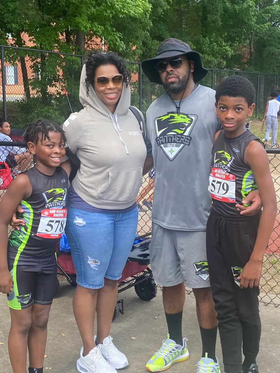 Athletes and coaches at a track event, showcasing team spirit and diversity.