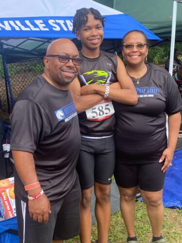Panthers Elite athletes with coaches at a track event.