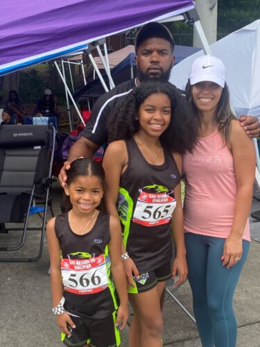Panthers Elite athletes with coach at track meet.