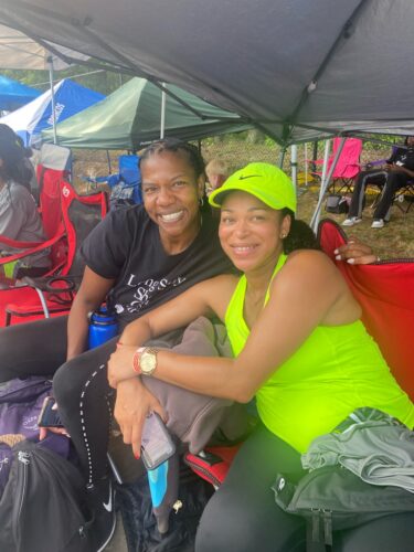 Athletes at Panthers Elite Track & Field Club event, smiling under a tent.