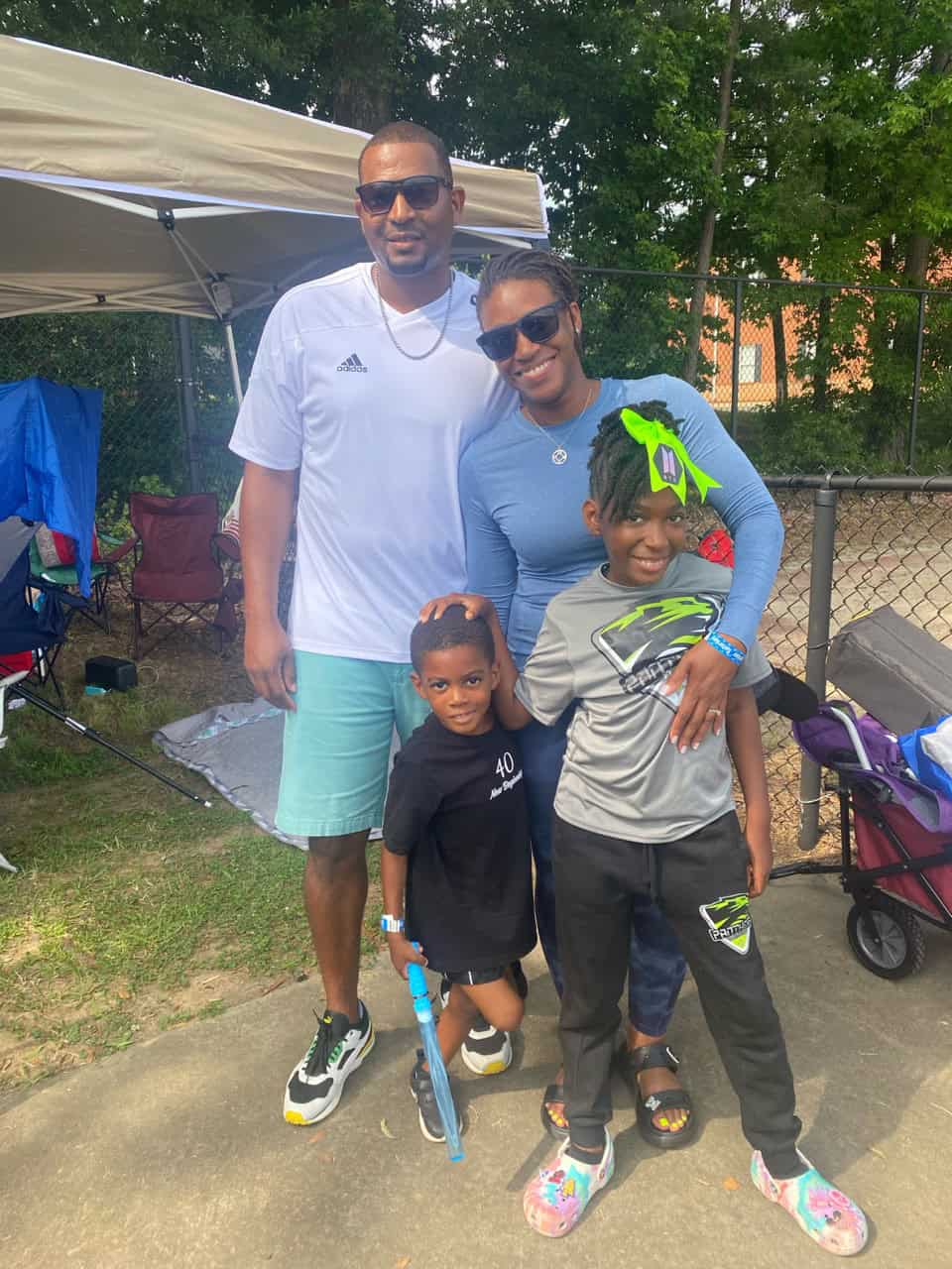 Family photo of Panthers Elite Track & Field members outdoors.