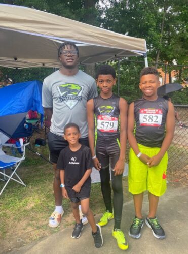 Young athletes at Panthers Elite Track & Field Club posing outdoors.