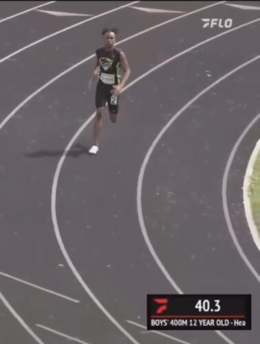 Young male runner competing in a track race.