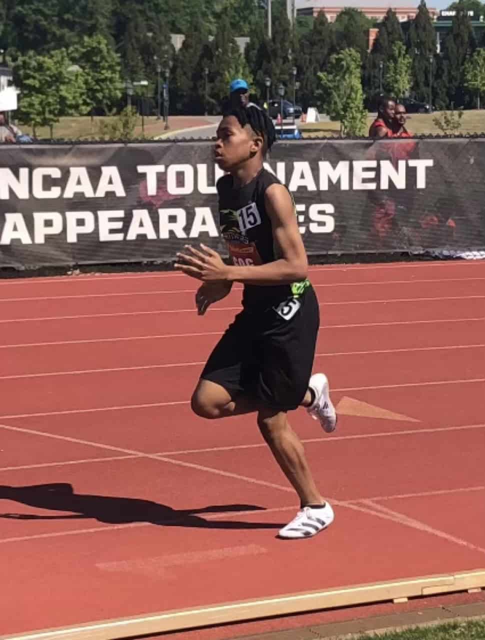 Athlete running on the track during a meet at Panthers Elite Track & Field Club.