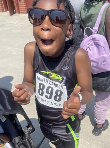 Panthers Elite Track & Field athlete smiling with sunglasses after race.