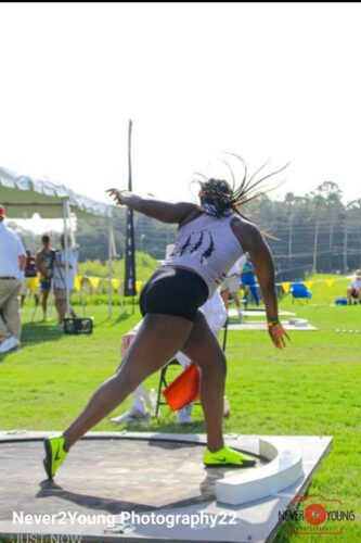 Track and field athlete preparing for a shot put throw.