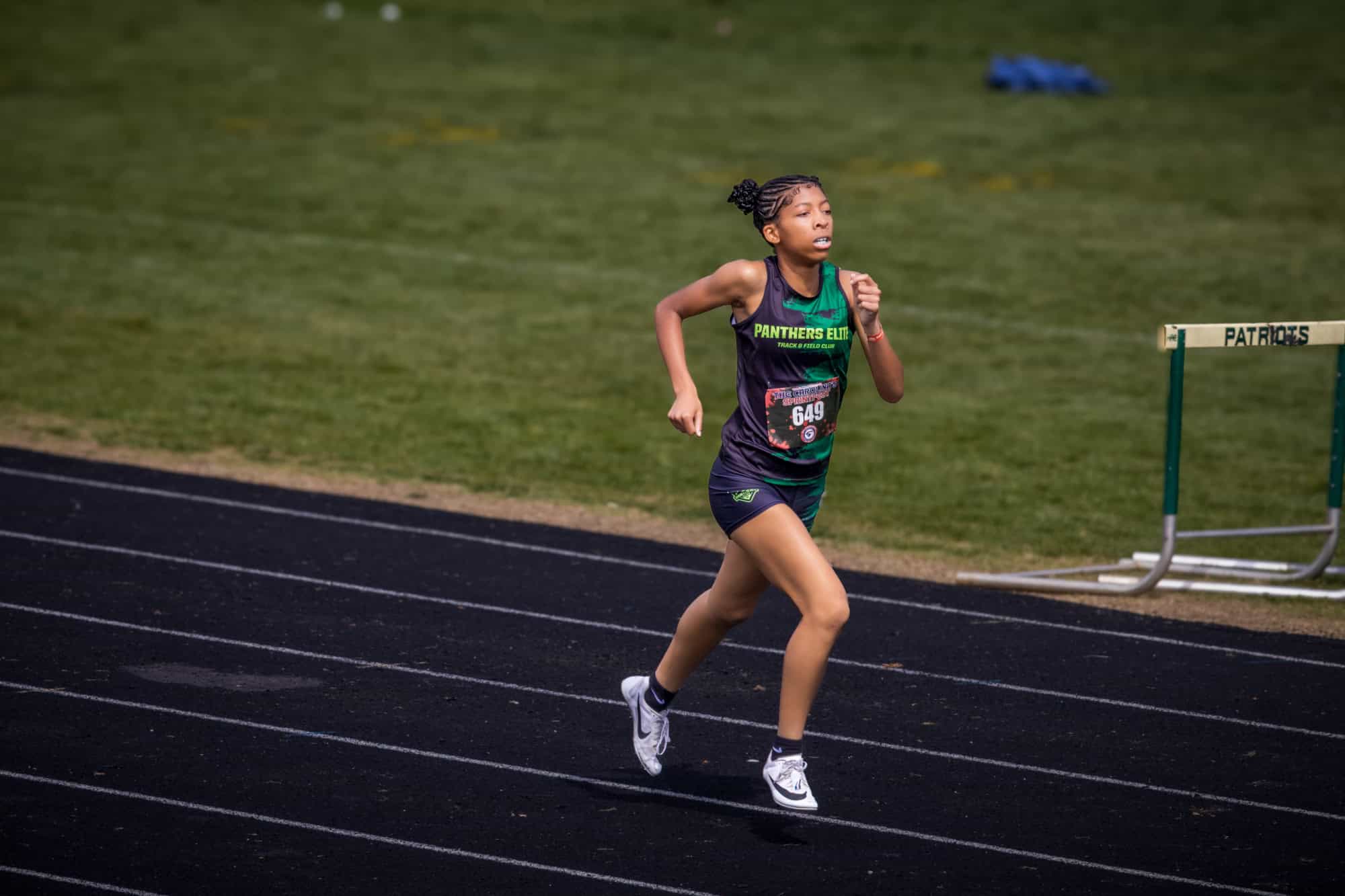 Athlete running on the track during a Panthers Elite Track & Field Club event.
