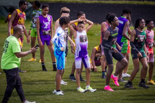 Young athletes ready at the starting line during a track meet.
