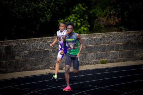 Young athletes competing in a track race at Panthers Elite.