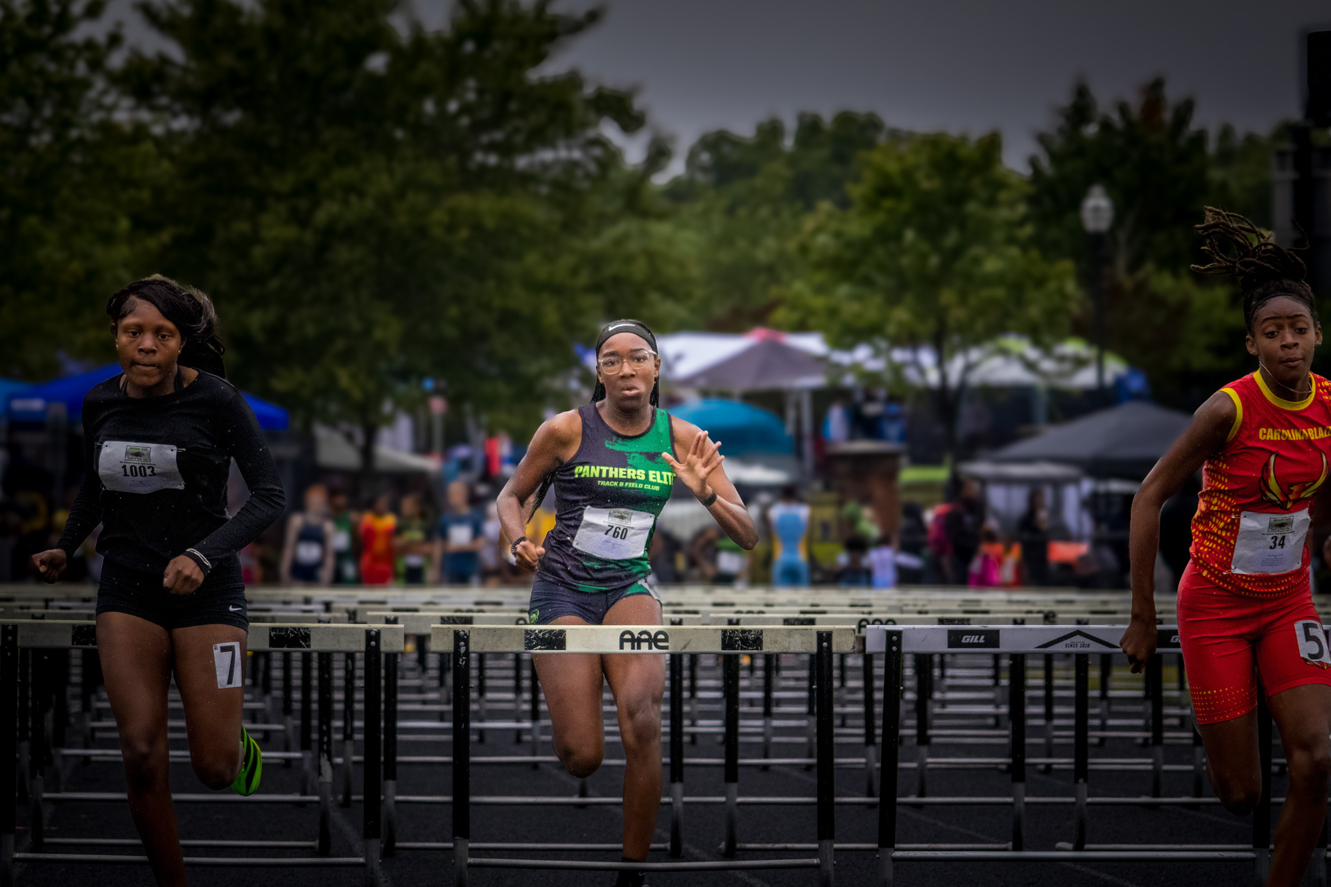 Female athletes competing in hurdles at Panthers Elite Track & Field meet.