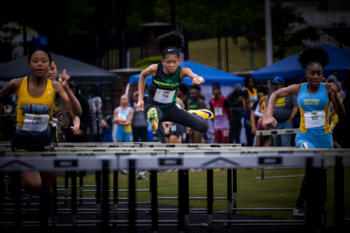 Athletes competing in hurdles at a Panthers Elite Track & Field meet.